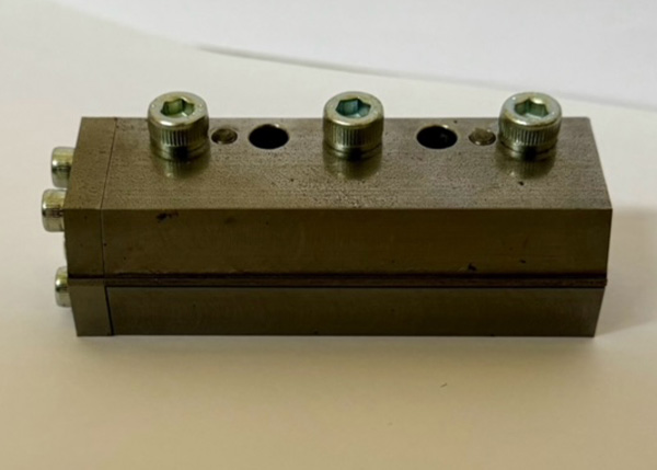 Precision-engineered adhesive module with multiple connection points and fittings.